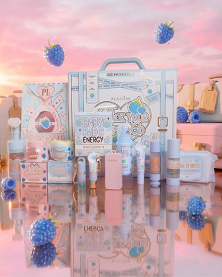 Collection of blue raspberry beauty products including the Pack Your Shit And Go bundle and the Obsessed For Less skincare bundles with a pink and blue colour scheme on a reflective surface.