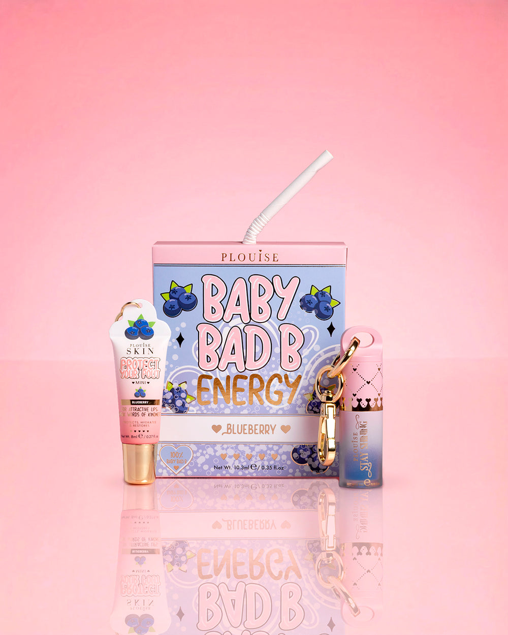 P.Louise Blueberry Baby Bad B Energy Mini Lip Conditioner and Lip Oil Duo on a pink background