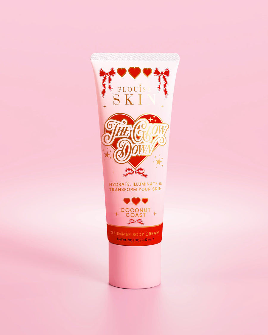 Pink tube of P.Louise The Glow Down shimmer body cream in coconut coast scent against a pink background