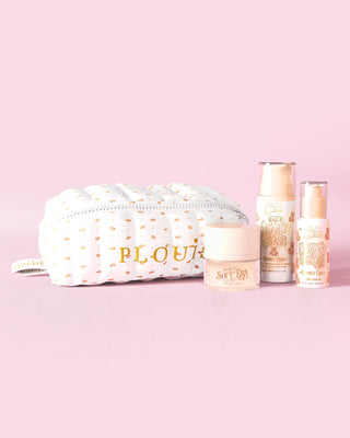 An image of P.Louise The Softest Touch Skincare Starter Kit with small print teddy makeup and skincare bag featuring 3 skincare products against a pink background